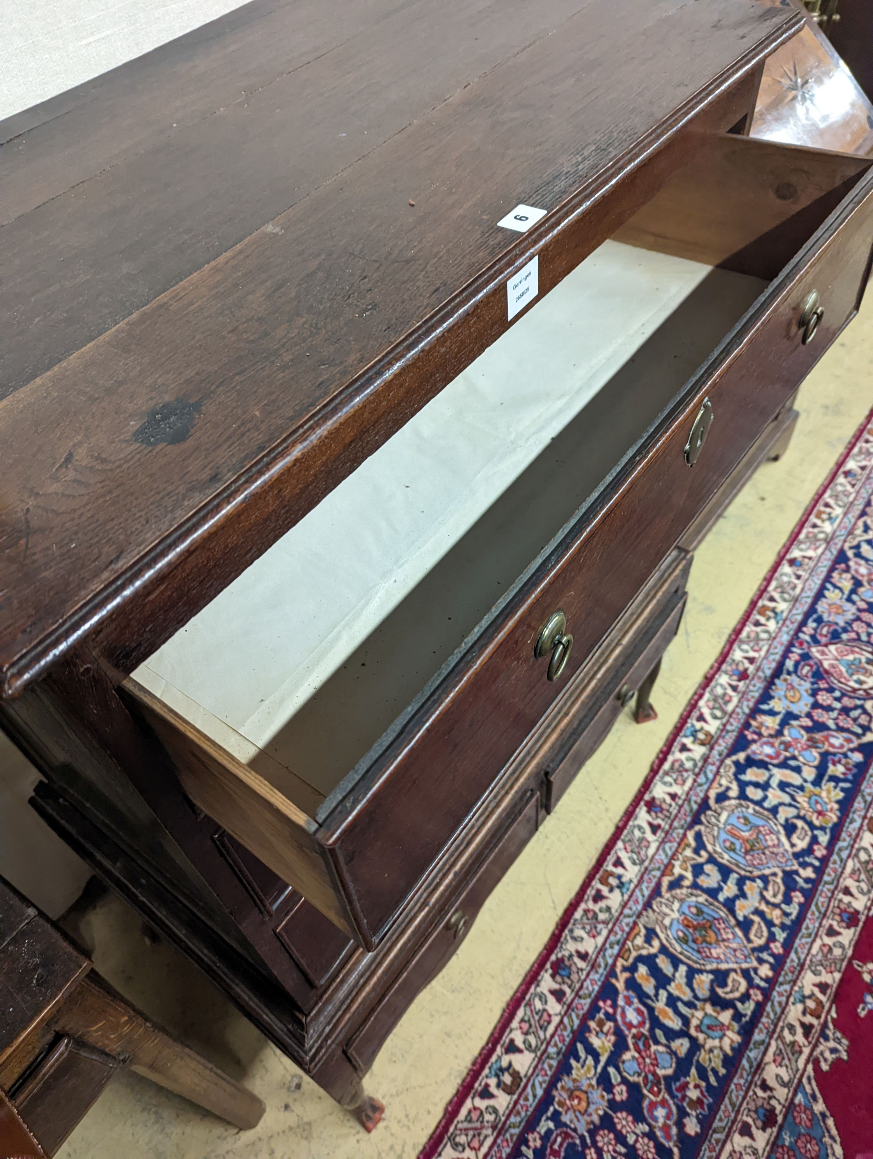 A mid 18th century oak chest on stand, width 89cm, depth 52cm, height 126cm